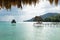 Sunlit dock at lake Itza with crocodile shaped mountain, El Remate, Peten, Guatemala