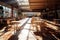 sunlit empty food court with scattered chairs