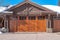 Sunlit exterior of home in Park City Uta with glass paned brown garage door