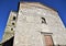 Sunlit facade and bell tower of the village of Coreglia Antelminelli.