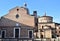 Sunlit facades of the cathedral and baptistery of Padua.