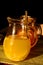 Sunlit glass jars with fresh grapefruit and orange juice.