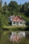 Sunlit house by Wilderness Lake in Tandridge Surrey on July 21, 2020