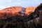 Sunlit mountains in the morning with larch trees in front