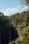 Sunlit Oasis: Tumpak Sewu Waterfall Framed by Mount Semeru