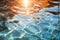 Sunlit pool water with glimmering reflections, revealing serene depths and shimmering ripples. Clear view of the