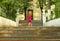 Sunlit portrait of a cute toddler girl posing on old blue stairs