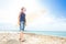 Sunlit portrait of teenager with surf board