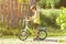 Sunlit profile portrait of six year old boy learning to ride a bicycle