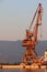 Sunlit red port crane in empty morning harbor of Rijeka Croatia