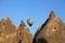 Sunlit rocks and hot air balloon on clear blue sky