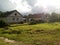 Sunlit rural street. One-story brick houses with front gardens and a green lawn in front of them. Joyful atomspheric photography.