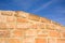 Sunlit sandstone brick wall as a background