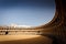 Sunlit seating surrounds the empty bullfight ring