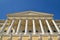 Sunlit towering columns and a portico at the entrance to the Rus