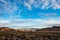 Sunlit valley view between dark hills in high desert landscape