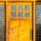 Sunlit wooden door with decorative glass panes
