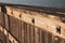 Sunlit wooden panel with metal details weathered by wind and rain