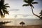 Sunlounge chairs and umbrella on the sunset beach in Florida Keys