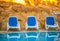 Sunloungers near swimming pool and reflected their in blue water