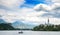 Sunning panoramic view of The island of Bled, Bled castle on cliff, Julian Alps and Church of the Assumption,Bled, Slovenia.