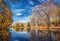 Sunny autumn in the park over lake