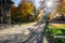 Sunny autumn street with stony road of Riga, Latvia