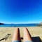 Sunny beach. Relaxing. Legs
