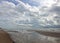 Sunny beach with sand dunes, beautiful cloud and blue sky