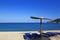 Sunny beach with wicker umbrella