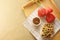 Sunny breakfast in bed with Belgium waffles, tea and tulips on wooden plate