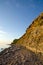 Sunny cliff steep at a stony coast