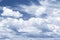 Sunny cloudscape blue sky with white cumulus clouds, tinted in classic blue. background backdrop sky. Weather idyllic cloudy sky