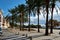 Sunny coastal palm lined street empty promenade leading along Mediterranean Sea, Palma de Mallorca