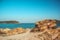 Sunny colorful Greece beach on Mediterranean sea rocky shoreline
