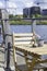 Sunny cozy seat at a wooden cafe table on the shore of Baakenhafen in Hamburg. View of the new Baakenpark in the
