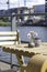 Sunny cozy seat at a wooden cafe table on the shore of Baakenhafen in Hamburg. View of the new Baakenpark in the