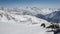 Sunny Day Above Clouds in Winter Snowy Alps Mountains. Time Lapse Dolly Shot over Rocks and Snow Drift