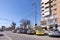 Sunny day in Bacau, a city in north-east Romania, with cars parked and orthodox church visible in the background