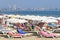 Sunny day at the beach in Alicante, Spain - umbrellas, beds, sun bath, holidays