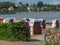 Sunny day on the beach of Eckernfoerde with hooded beach chairs on the sand, Germany