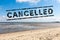 Sunny day beach and text cancelled - vacation cancel