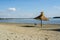 Sunny day on the beaches whit single umbrella made from reed or cane