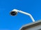 On a sunny day beneath a clear blue sky, a security camera ensures safety