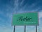 On a sunny day with blue sky, the Welcome to Fetlar sign at the Hamars Ness ferry terminal on the island of Fetlar in Shetland