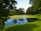 Sunny day on a calm pond lake in summer