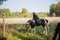 On a sunny day, the girl takes a ride on horseback through the expanses of her estate