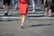 On a sunny day, pedestrians cross the street through a pedestrian crossing. There are pedestrian shadows on the street. View from