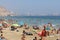 Sunny day at the sand beach in Alicante, Spain - holidays, swimming, umbrellas