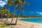 Sunny day on sandy beach with palm trees, Airlie Beach, Whitsundays, Queensland Australia